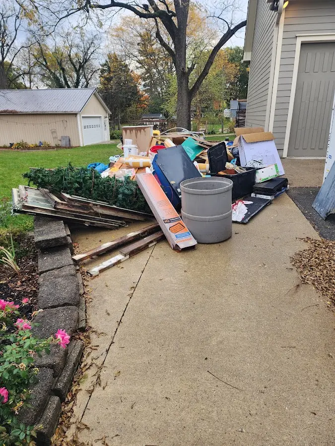 Dumpster being loaded with debris for Roofing Dumpster Rental in Jacksonville